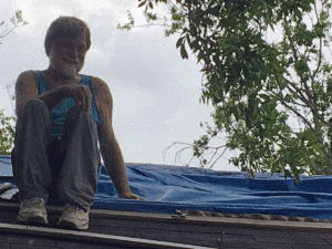 Photo of author on roof with snake.