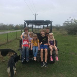 Photo of grandnephews and grandnieces plus a friend and dogs Oso and Maya after visiting the farm to see our fish.