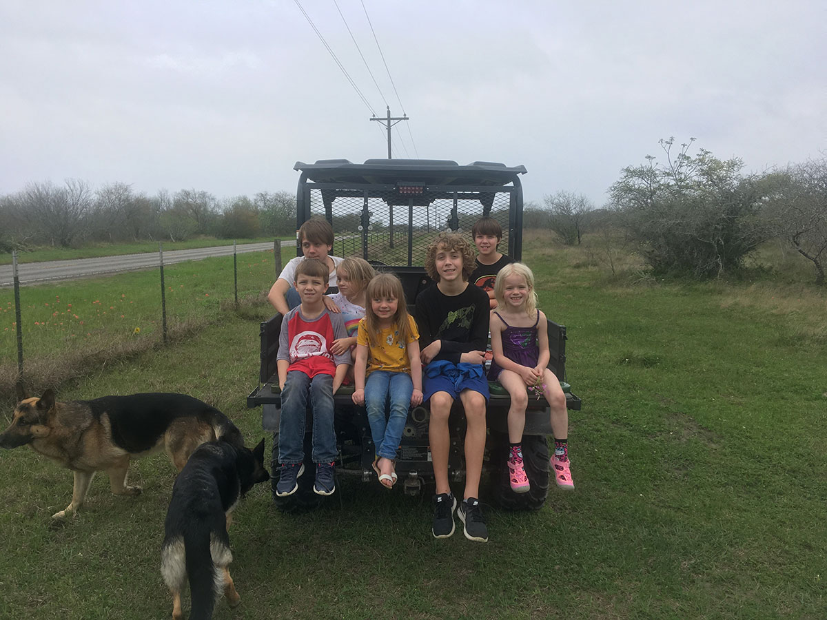 Photo of grandnephews and grandnieces plus a friend and dogs Oso and Maya after visiting the farm to see our fish.